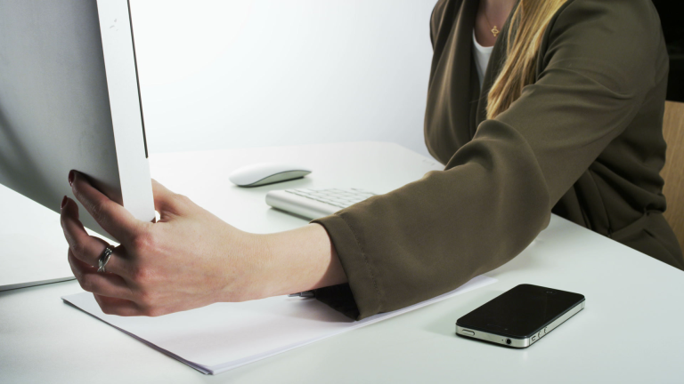 Woman Turning Computer On